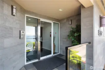 Main entry. Condo on the left. Or use level entry to garage and take elevator.