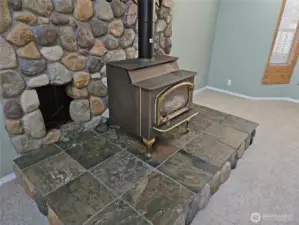 Nice river rock adornment around the wood stove