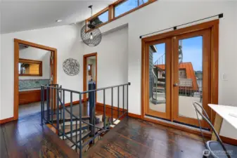 Work spaThe upstairs landing has soaring ceilings allowing massive light to fill in the space. ce or a peloton!