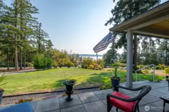 A wonderful view of the sound from you patio, sit in the sun or under the large covered area.