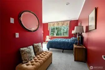 Room for a seating area in the freshly painted primary bedroom.