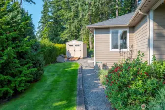 Side view of home with new storage shed.
