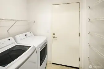 The utility room connects the garage to the kitchen. Lot's of shelves make unpacking groceries a breeze.