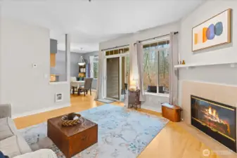 The open-concept living area centers around a cozy tile-surround fireplace and low-maintenance laminate flooring.