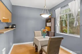The dining area flows effortlessly into the kitchen, separated by a breakfast bar for additional seating.
