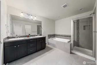 Primary Bath. Double vanity, bathtub, shower and separate toilet area.
