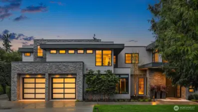 Tucked down a tree-lined street, this home is thoughtfully sited for maximum privacy.