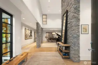 Stone and wood accents anchor the soaring 2-story entry.