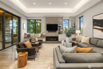 The family room is an invitation to relax with its cozy fireplace flanked by a window seat and custom built-ins.