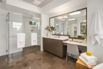 The curbless walk-in shower features a waterfall showerhead.