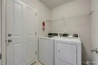 Practicality meets convenience with a utility / mudroom located just off the main living space, and attached to the two-car garage, providing ample storage space and making chores like laundry or unloading groceries a breeze.