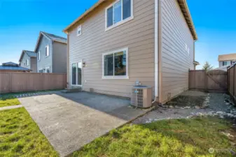 The expansive back patio is perfect for alfresco dining, casual BBQs, or simply unwinding in the tranquility of your outdoor space.