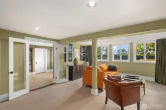 Bay windows from media area look out to yard and views. Large area with space for games, plus dedicated workout room, bedroom, 3/4 bath and full kitchen. Two exterior doors walk out to grassy yard and patios.