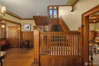 Gracious entry foyer with original millwork, pocket doors, original light fixture plus large coat closet and entry bench. The large glass front door is flanked by leaded glass side lights.