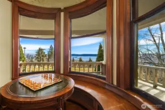 Enjoy the privacy and quiet of this enchanting property from this nook with built-in bench and curved windows.