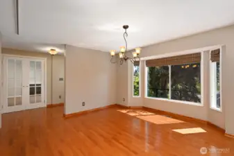 Large living room with space for over sized dining table and bookshelves or displaying art on amply sized walls.