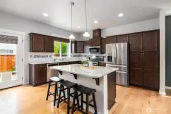 Kitchen with granite slab, center island and stainless appliances (all appliances stay)