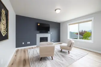 Primary suite seating area with gas fireplace