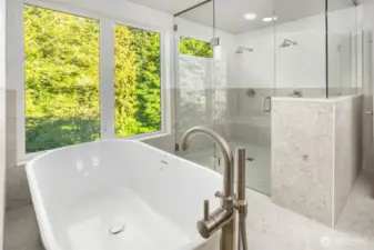 Soaking tub with a view and oversized shower with frameless glass surround
