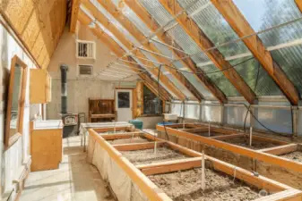 Raised beds, utility sink, overhead sprinklers, wood stove and more!