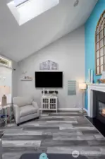 Vaulted ceilings and skylights create an open feel in this sunken living room.