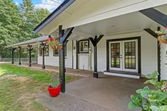 Covered front porch area with French doors entering into kitchen.