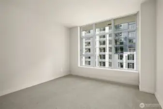Large bedroom with walk-in closet and brand new carpet.