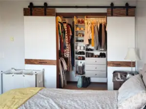 Primary bedroom walk-in closet with new barn doors.