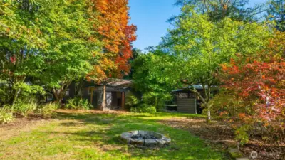 Fire pit for summer s'mores located near the back of this very private property.