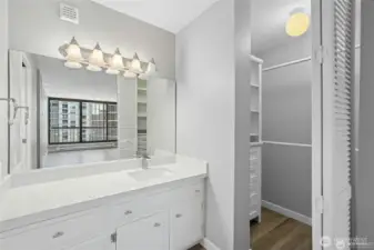 Primary vanity with closet to the right of vanity