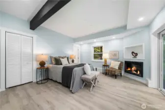 On the lower level, a gorgeous 2nd primary suite awaits, with a gas fireplace and views of sky and trees. The private luxury bath offers both a walk-in shower and separate soaking tub, plus a walk-in closet with shelving built right in. Step out through the slider to the serene back yard – a great spot to add a table and comfy chairs for your morning coffee.