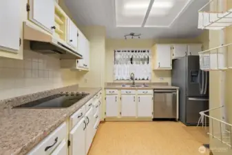 Kitchen with ample cabinetry and counter space .