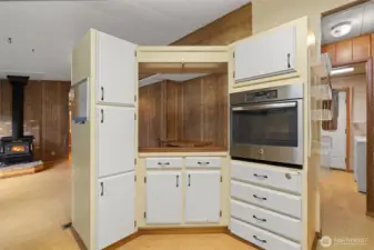 Kitchen featuring built-in oven and cabinet storage