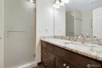 shared bathroom with matching quartz and cabinetry!