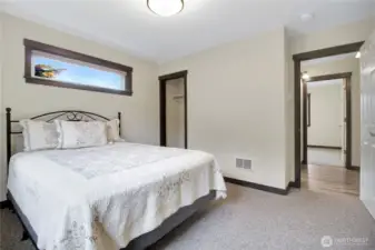 Closet space with bathroom and hallway to the right.