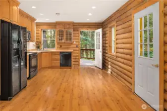 Open door leads from kitchen to large deck on back of home