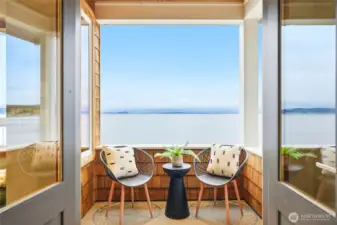 French doors open to a private covered balcony.