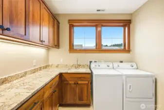 Quality materials continue in the large utility room. Cabinetry galore!