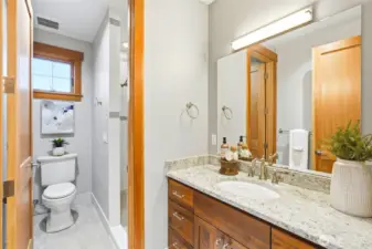 3/4 bath around corner. Again, tile, granite, quality cabinetry, fixtures, heated floors.