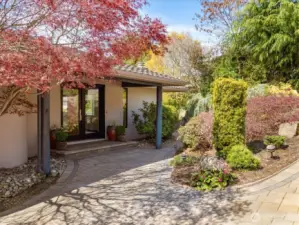 The professionally landscaped yard is filled with seasonal beauty throughout the year.