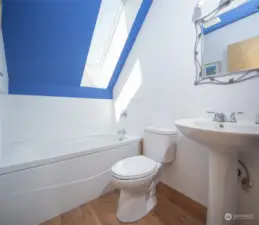 upper level bath with jetted tub and skylight