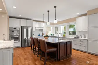 The stylish & bright kitchen is designed with an expansive entertaining island & stainless steel appliances