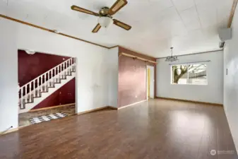 Living room flows into dining space and into kitchen and bath.