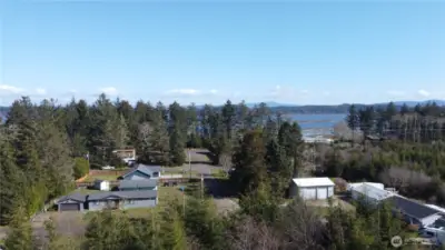 Drone shot looking towards bay from right at the east side of property