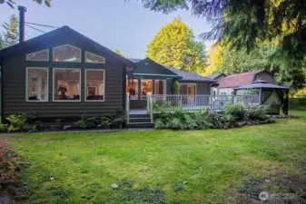 Back of house with deck and hot tub