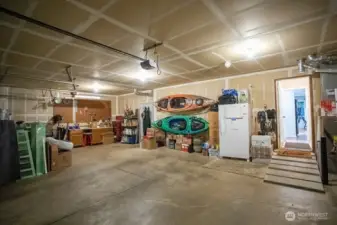 Inside garage, leading into home with laundry room and half bath