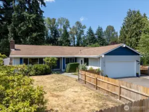 Fenced in front yard is ready for your special touch.