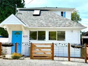Cute cottage with a new roof and sweet little front porch.