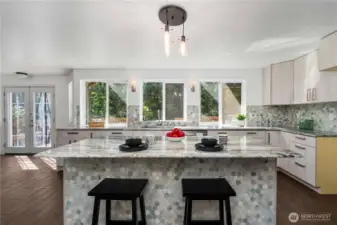 Renovated kitchen features granite countertops, custom cabinetry, and stunning backsplash.