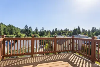 Refreshed deck with new boards and rails for added durability, offering a relaxing space to enjoy views of lush greenery above the roofline.